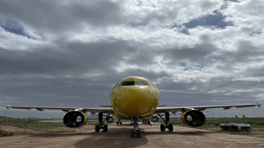 A Spirit Airlines plane heads into the desert, led by a repo pilot.